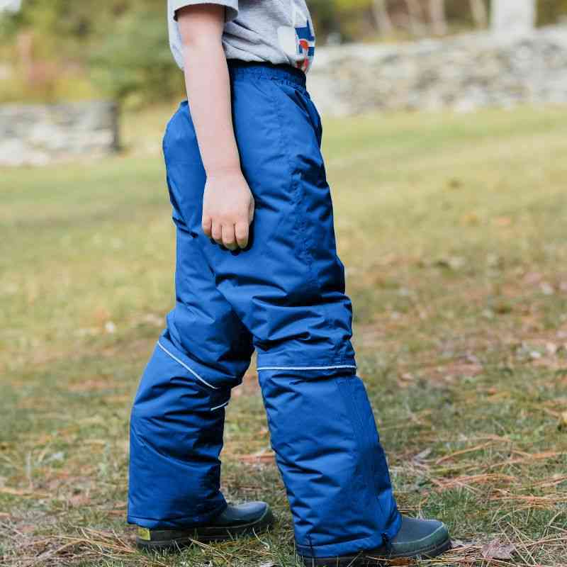 Child wearing the One Kid Royal Blue Arctic Snow Pants outdoors, highlighting their comfort and flexibility during cold-weather activities.