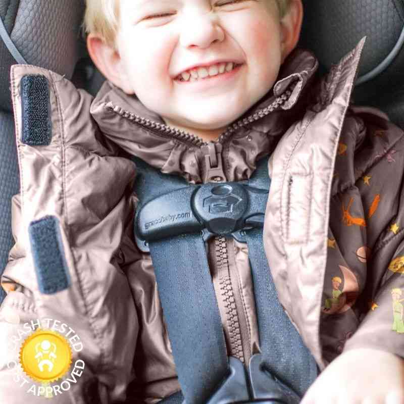 Boy in little prince print Road Coat Vegan safely buckled in car seat – crash tested car seat coat
