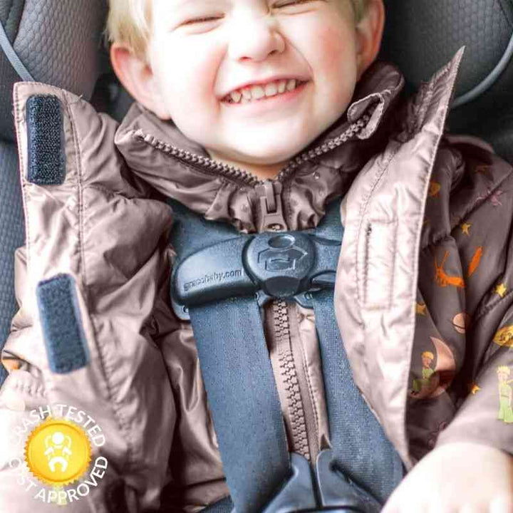 Boy in little prince print Road Coat Vegan safely buckled in car seat – crash tested car seat coat