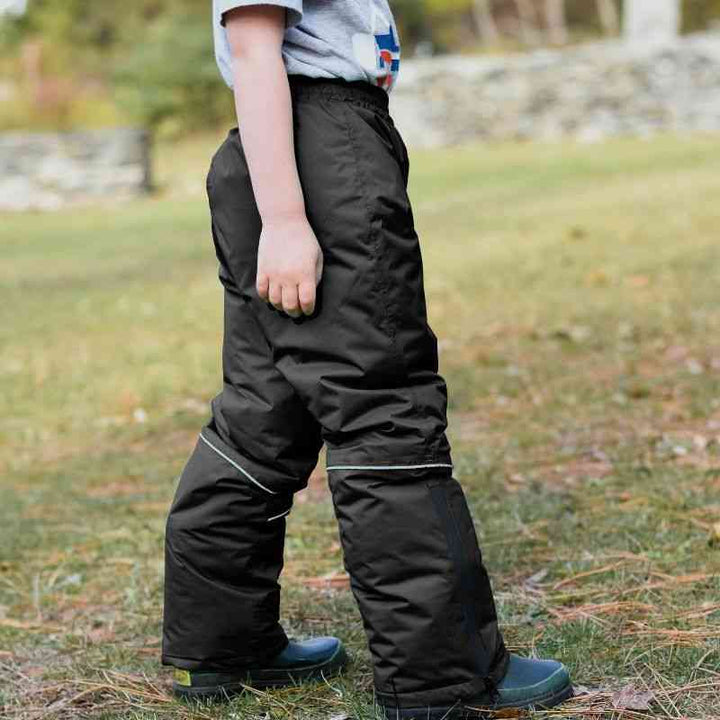 One Kid Arctic Pack-able Snow Pant – Black side view highlighting fully sealed seams, snow guard, and lightweight insulated fabric.