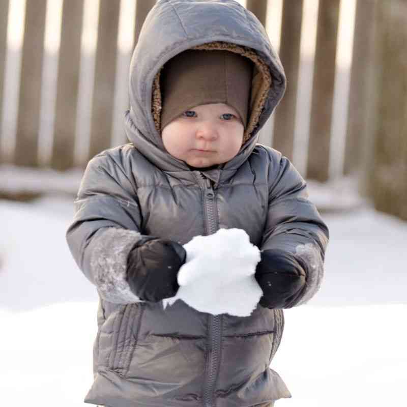 Assorted colors of One Kid Mittens displayed in a circle, including navy, pink, and purple.