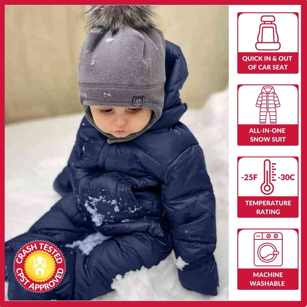 Baby in navy snow suit with crash test approval